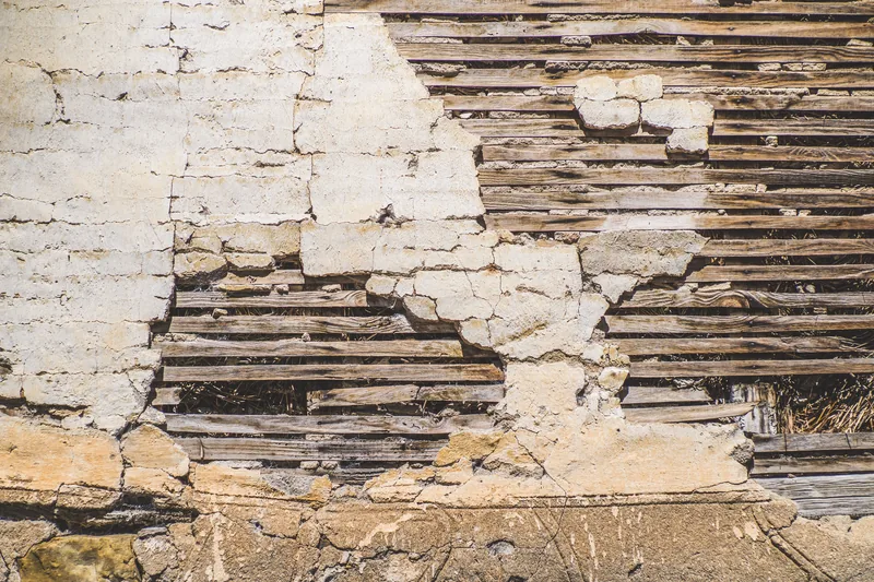 Plaster over lath, exposed behind a cabinet run