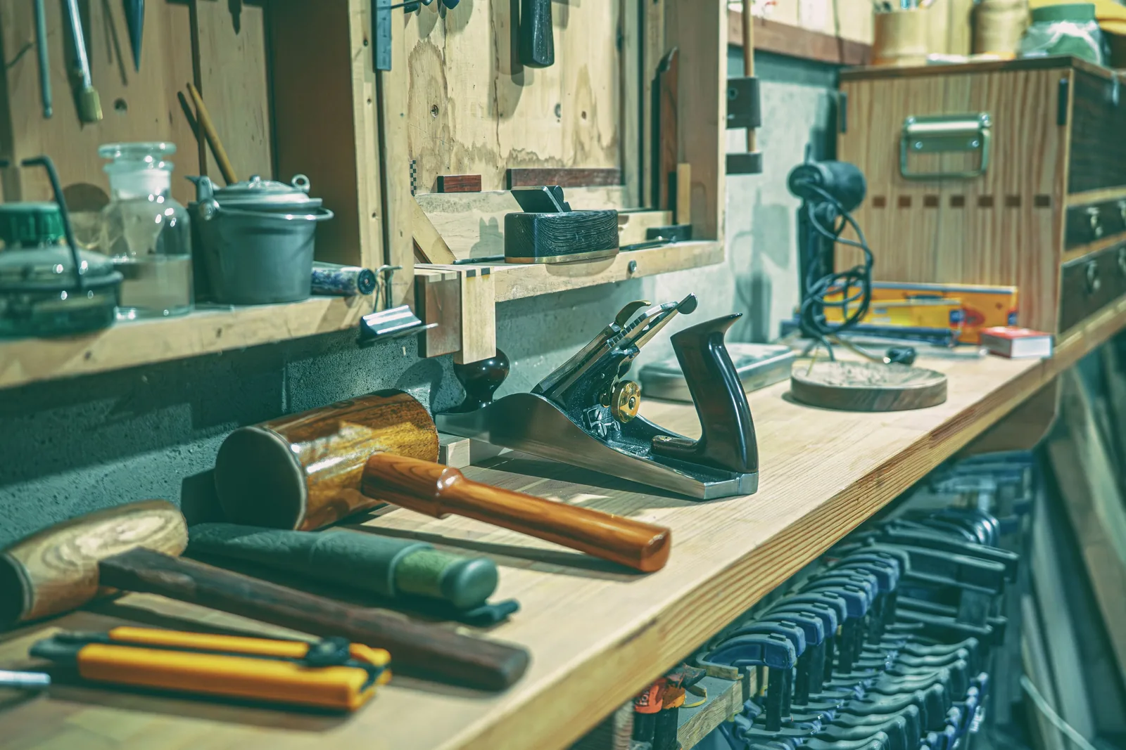 A cabinet shop bench with clamps and hand tools