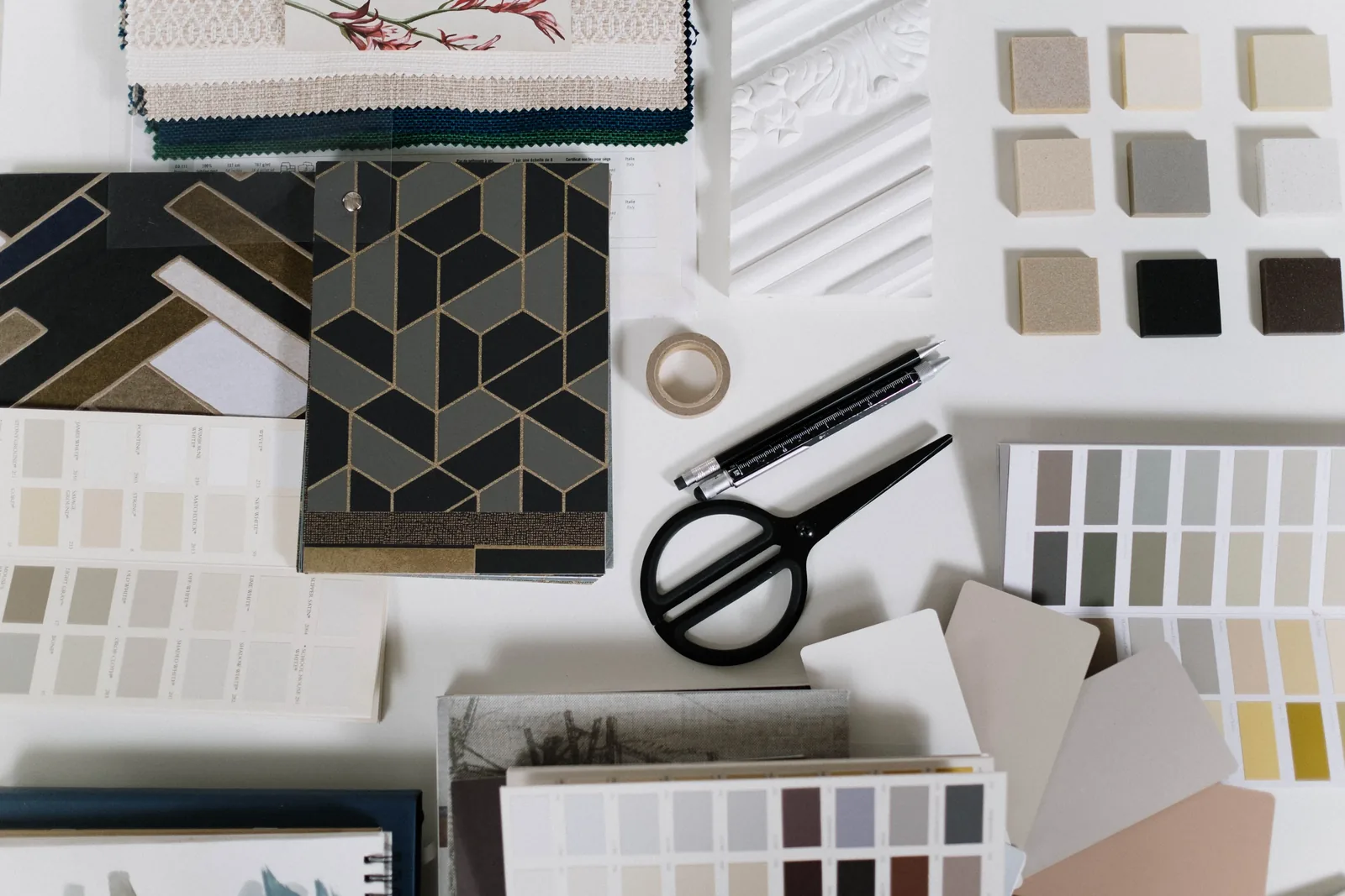 Drawings, a tape measure and finish samples on a table